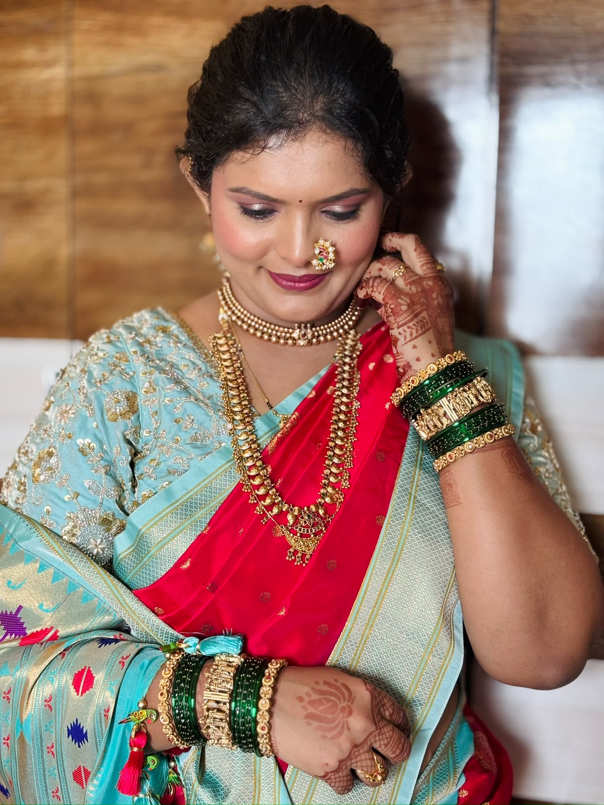 Hand with gold bracelets and mehendi